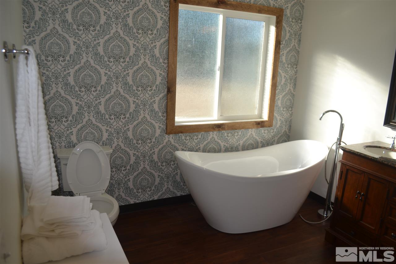 1100 McLean Road Fallon, NV 89406 - Photo 7 of 9 a white bath tub sitting in a bathroom