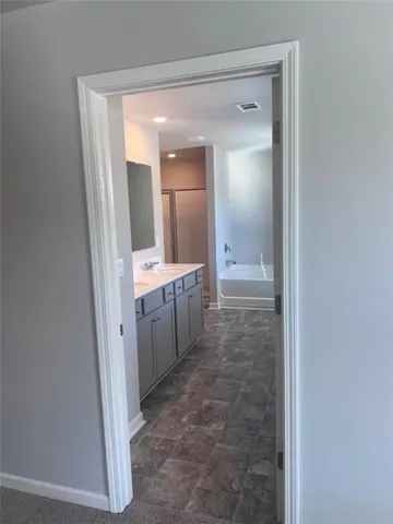 a bathroom with a double vanity sink and mirror