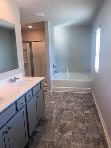 a bathroom with a bathtub and a sink
