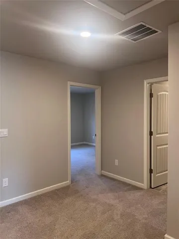 an empty room with closet and a window