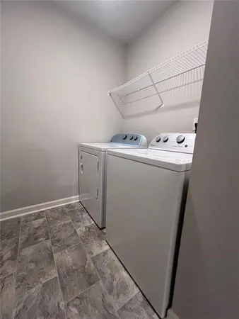 a view of storage and utility room with washer and dryer