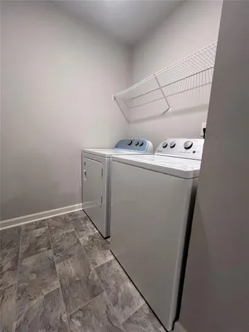 a view of storage and utility room with washer and dryer