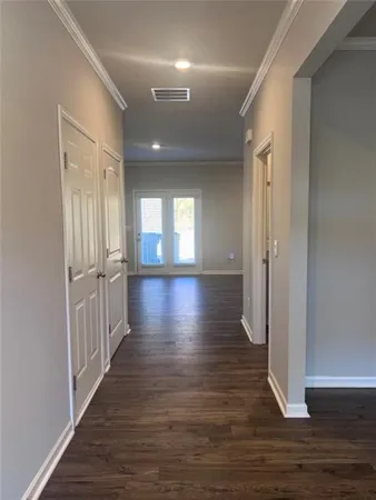 a view of hallway with wooden floor