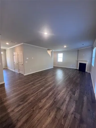 a view of a room with wooden floor