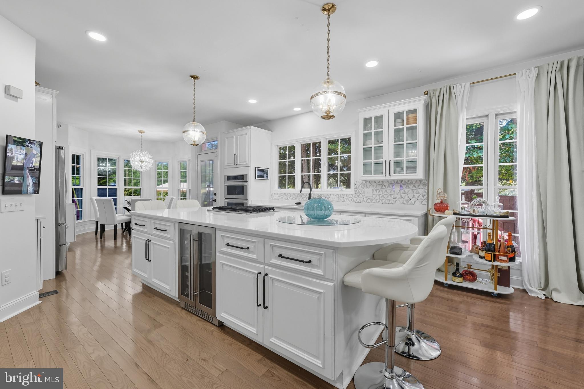 2725 Robaleed Way Herndon, VA 20171 - Photo 12 of 45 a kitchen with stainless steel appliances granite countertop a stove top oven a sink dishwasher a dining table and chairs with wooden floor