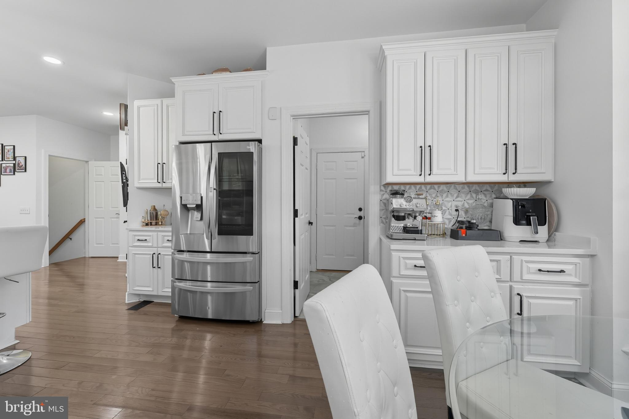 2725 Robaleed Way Herndon, VA 20171 - Photo 13 of 45 a kitchen with white cabinets and stainless steel appliances