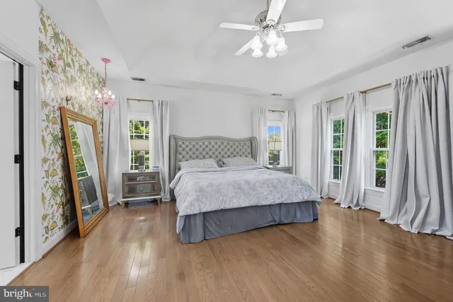 a bedroom with a bed next to a large window with the outer view