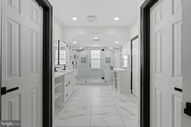 a bathroom with a glass shower door and a bathtub