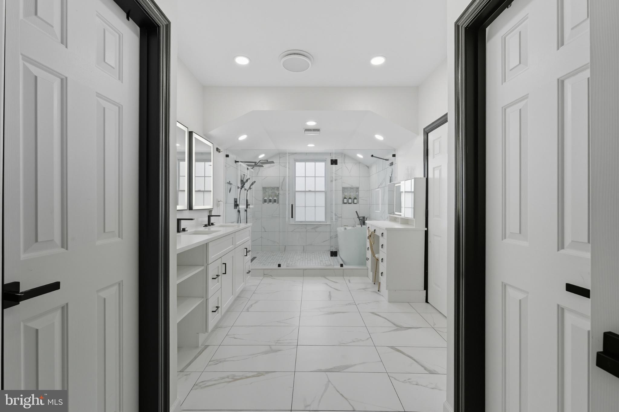 2725 Robaleed Way Herndon, VA 20171 - Photo 20 of 45 a bathroom with a glass shower door and a bathtub