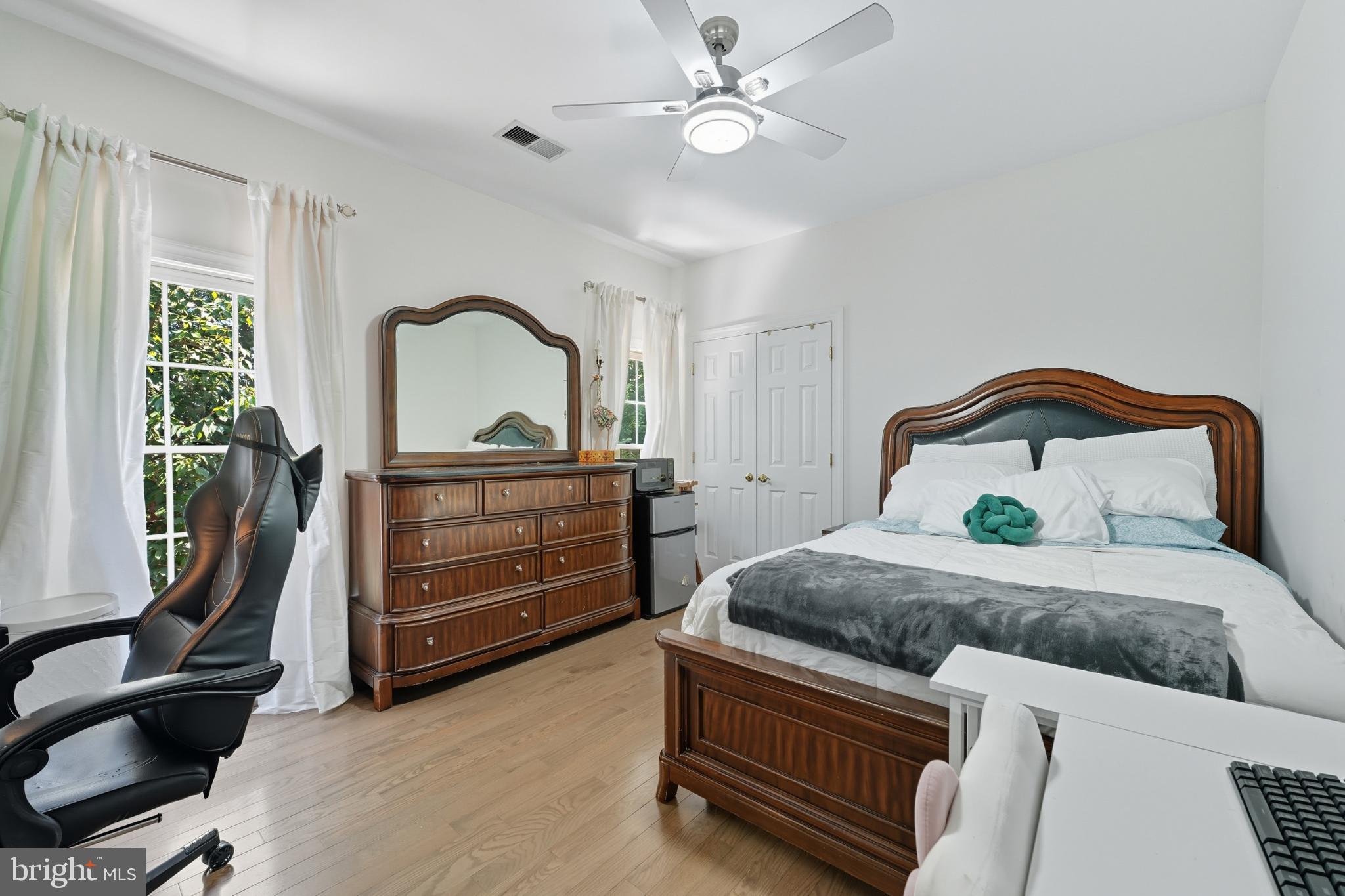 2725 Robaleed Way Herndon, VA 20171 - Photo 25 of 45 a bedroom with a bed and a chandelier