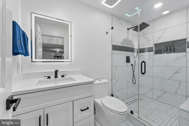 a bathroom with a toilet sink and shower