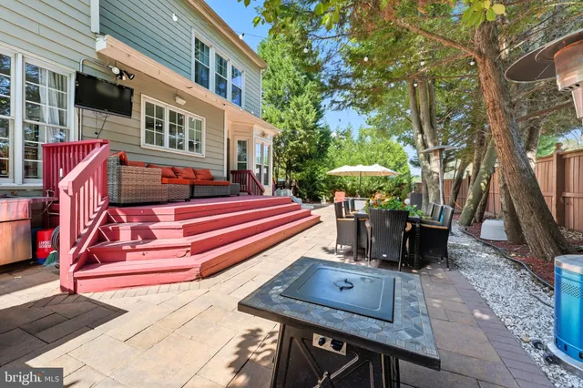 a view of a patio with a table chairs and a potted plant