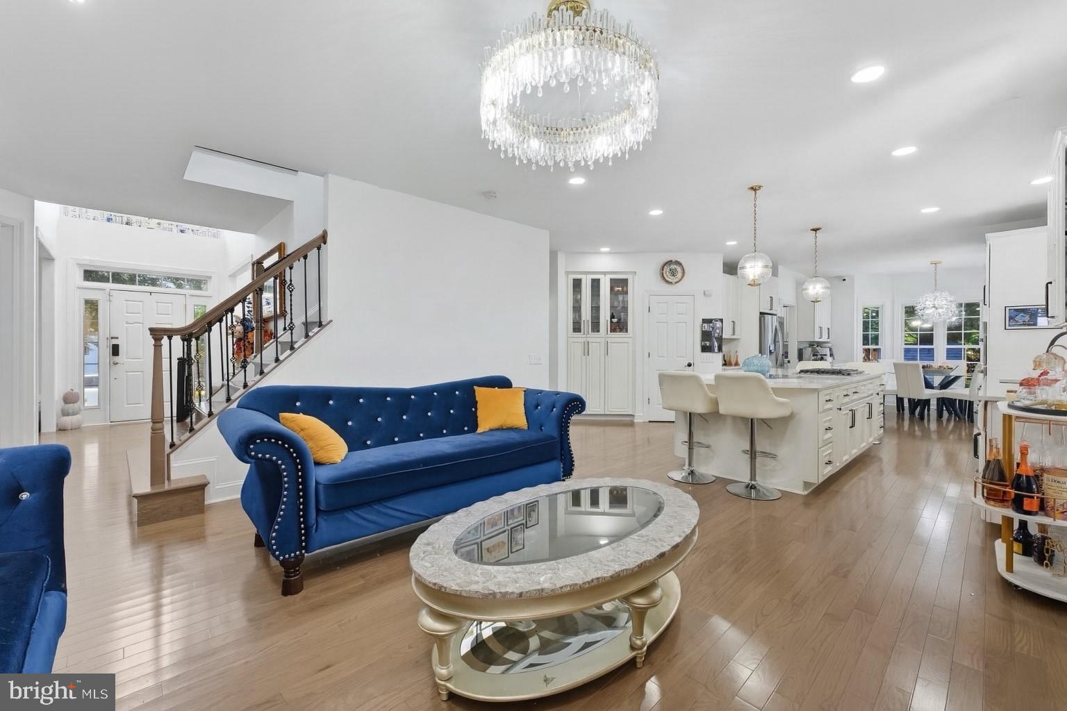 2725 Robaleed Way Herndon, VA 20171 - Photo 10 of 45 a living room with furniture and a chandelier