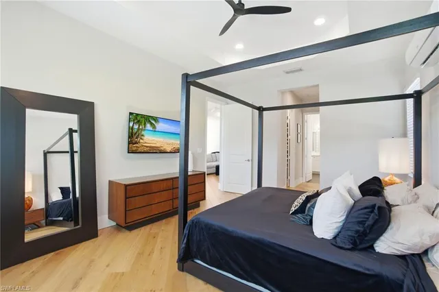 a spacious bedroom with a bed and a window