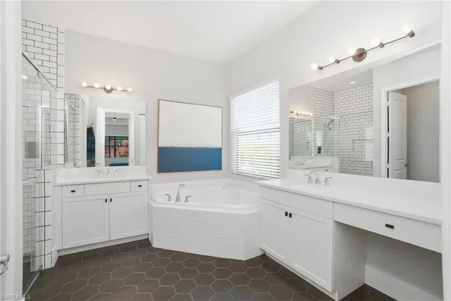 a bedroom with a bed and a dresser with mirror