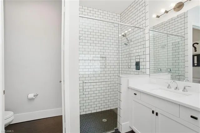 a bathroom with a double vanity sink a mirror and a bathtub