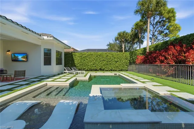 a view of washer and dryer with bathroom in the background