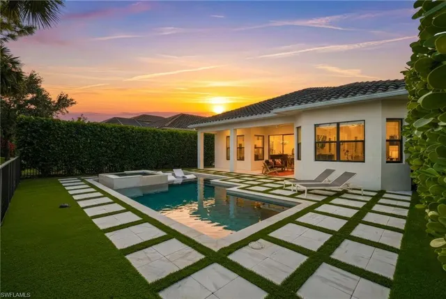 a view of a patio with swimming pool table and chairs