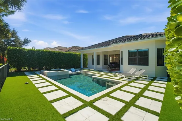 a view of a swimming pool with a lounge chairs
