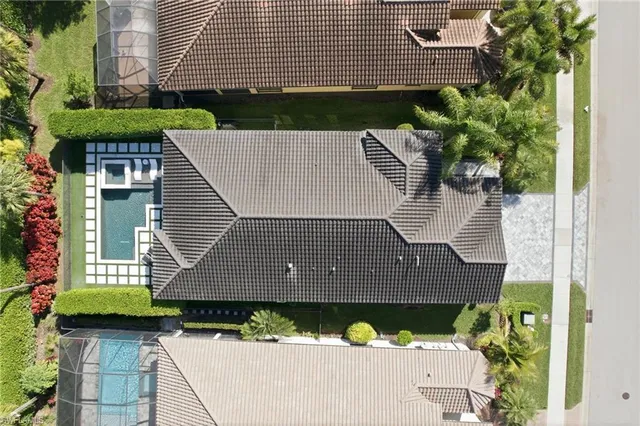 a view of a house with swimming pool and sitting area
