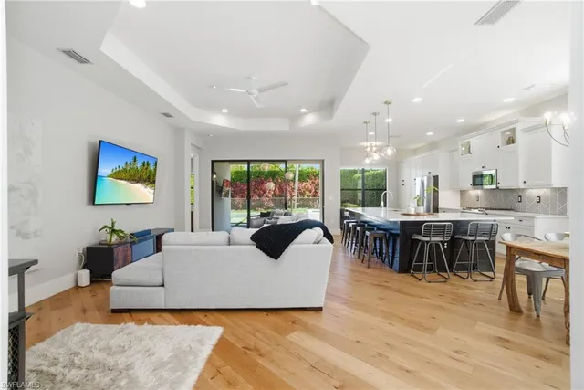 a living room with furniture a dining table and kitchen view
