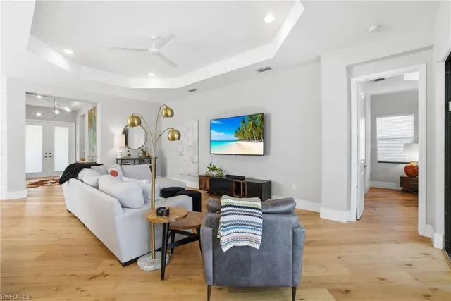 a living room with furniture and a view of bedroom