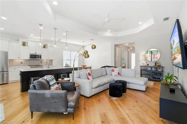 a living room with furniture and kitchen view