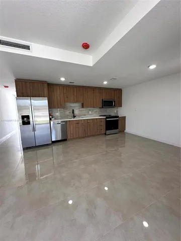a kitchen with a sink and counter top space