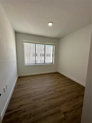 a view of an empty room and wooden floor