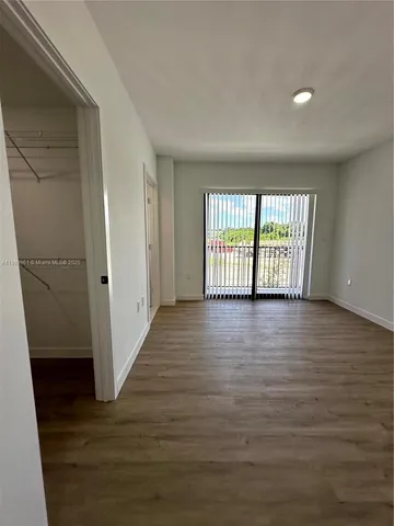 a view of a room with wooden floor