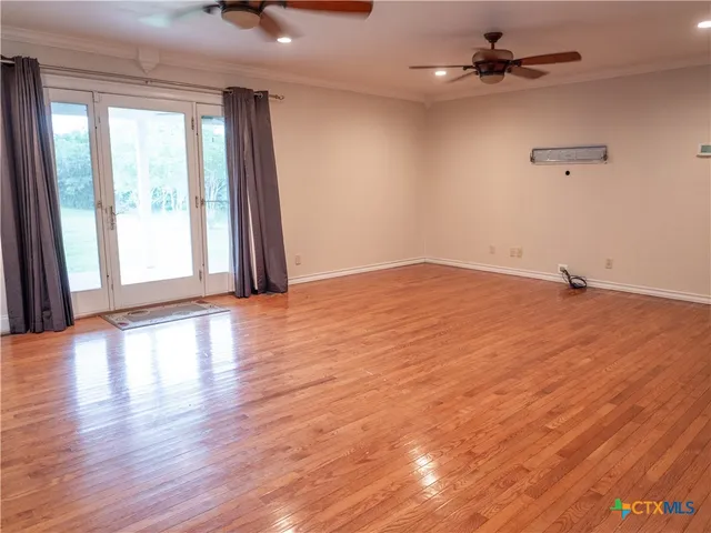 wooden floor in an empty room with a window