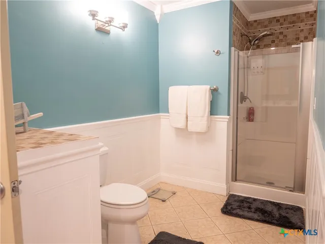 a bathroom with a granite countertop sink a toilet and shower