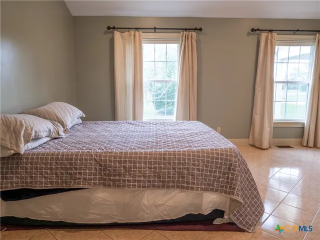 a view of a chair and table on the wooden deck