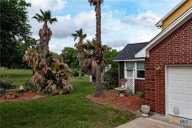an aerial view of a house with garden space and street view