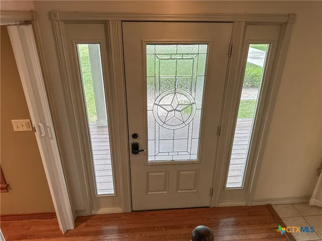 a view of front door with wooden floor