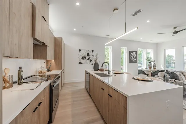 a kitchen with sink stove and cabinets