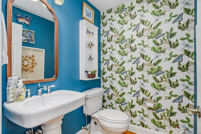 a bathroom with a sink toilet and mirror