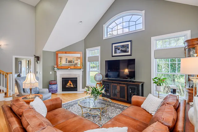 a living room with fireplace furniture and a flat screen tv
