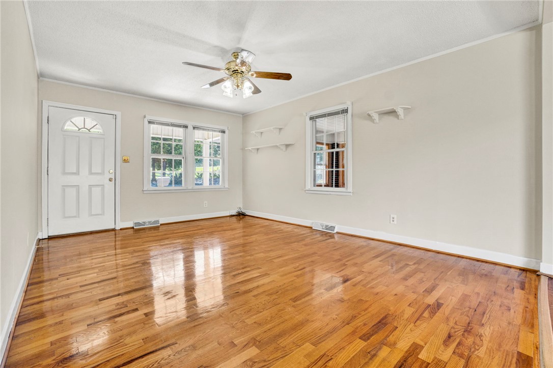 7876 Highway 11 Walhalla, SC 29691 - Photo 11 of 35 Refinished hardwood floors and generous windows elevate this inviting living space.