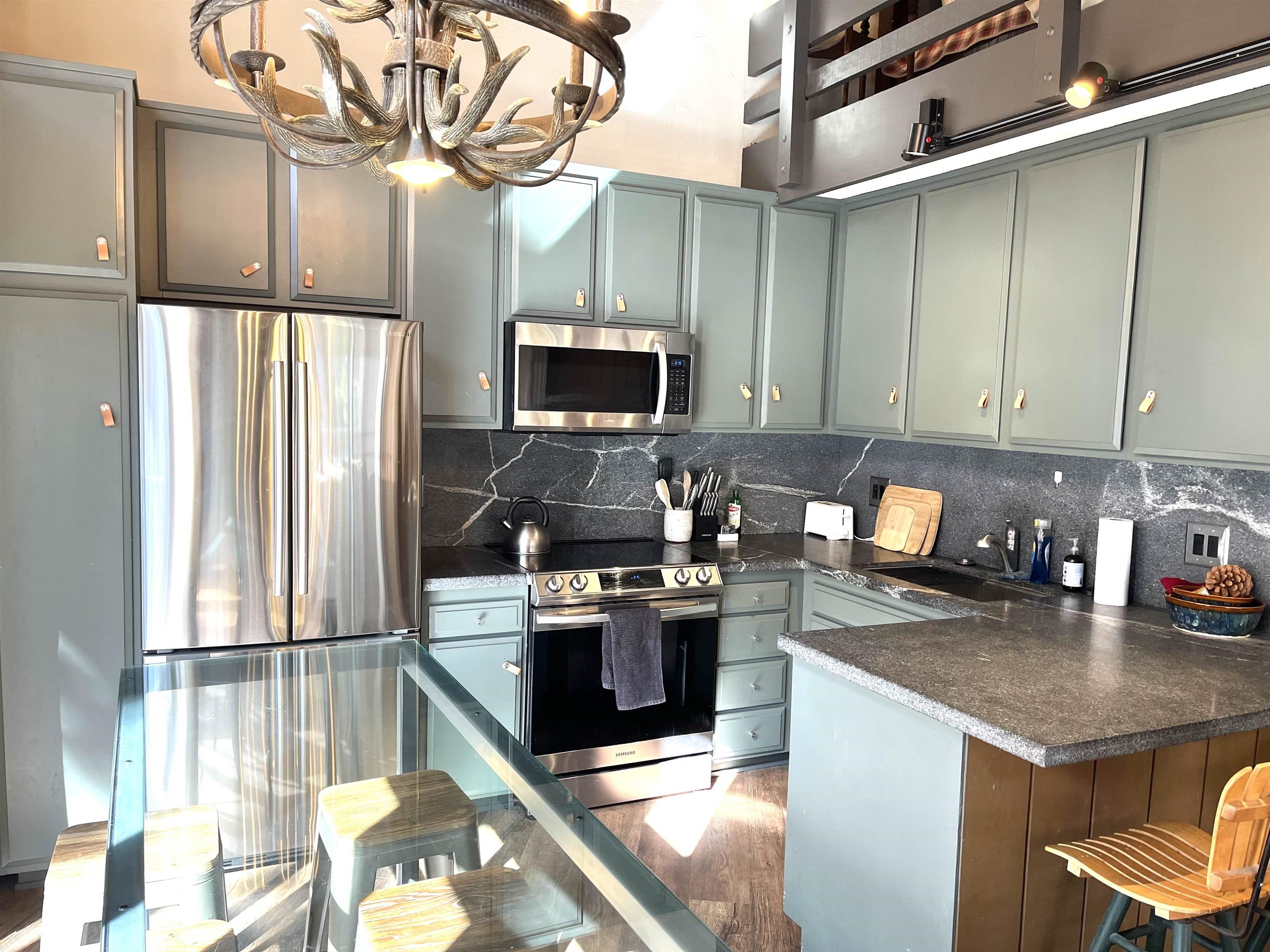 286 Old Mammoth Road, Unit 7 Mammoth Lakes, CA 93546 - Photo 12 of 31 a kitchen with stainless steel appliances granite countertop a refrigerator a stove top oven a sink and dishwasher