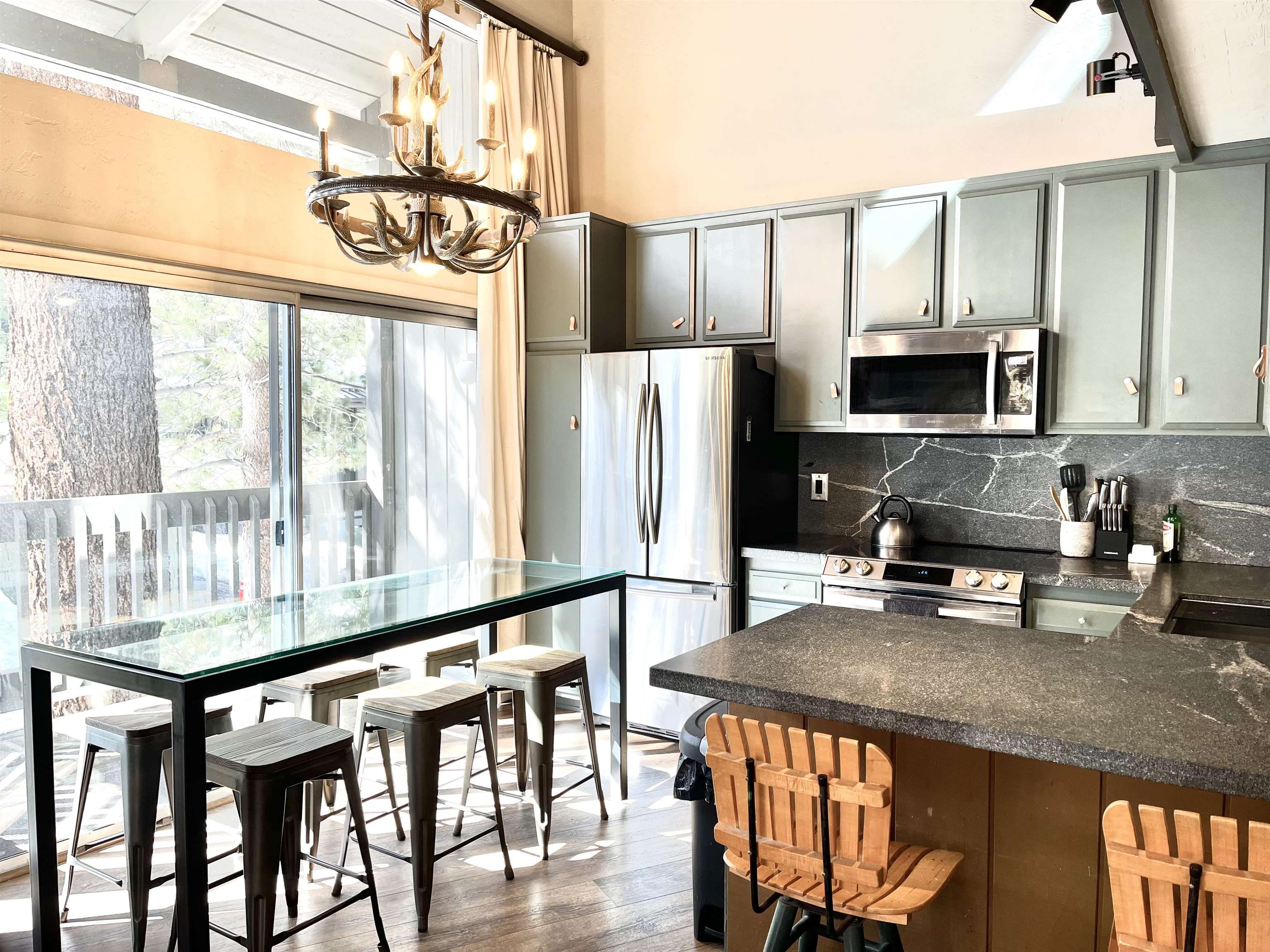286 Old Mammoth Road, Unit 7 Mammoth Lakes, CA 93546 - Photo 10 of 31 a kitchen with stainless steel appliances granite countertop a stove a refrigerator and a dining table with granite countertops