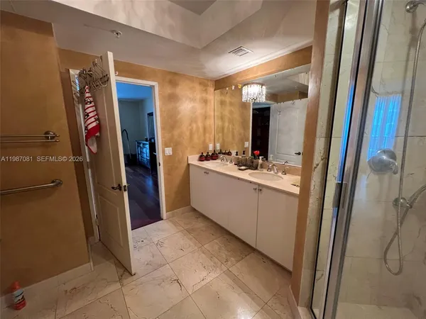 a bathroom with a sink a mirror and a shower