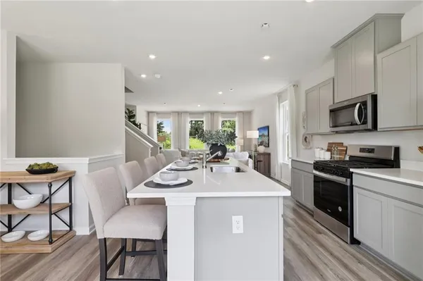 a kitchen with stainless steel appliances kitchen island granite countertop a sink and cabinets