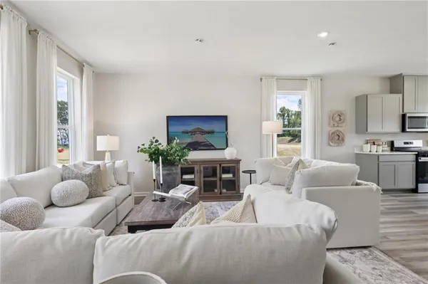 a living room with furniture and a large window