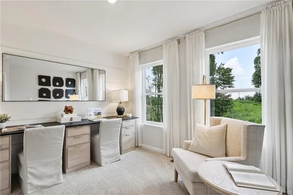 a living room with furniture a large window and a dining table
