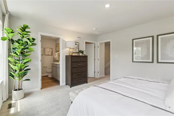 a bedroom with a bed and a dresser