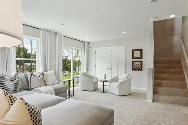 a living room with furniture and large windows