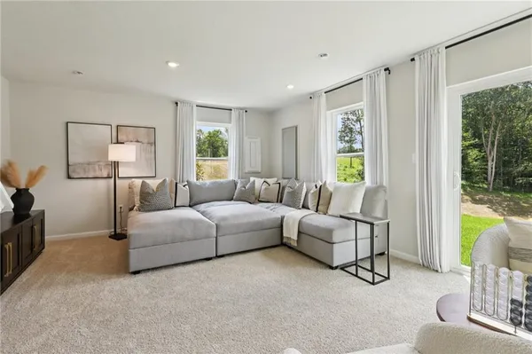 a living room with furniture and a large window