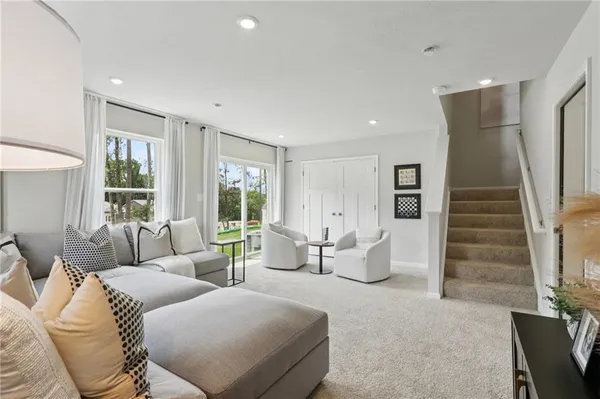 a living room with furniture and a large window