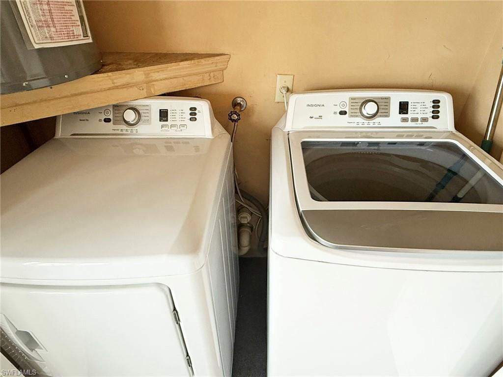 2005 Pine Isle Lane, Unit 2005 Naples, FL 34112 - Photo 13 of 23 Laundry area featuring washer and clothes dryer.